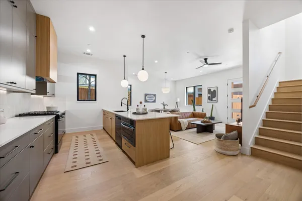 a kitchen with a sink stove and cabinets
