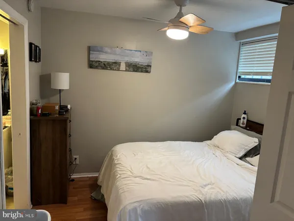 a bedroom with a bed and a lamp