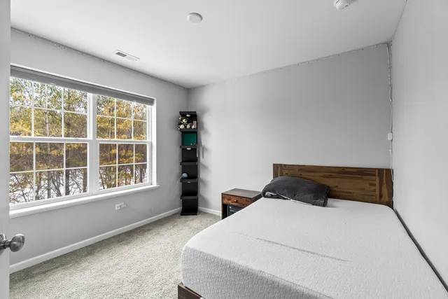 a bedroom with a large bed and a large window