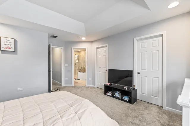 a bedroom with a bed and a television