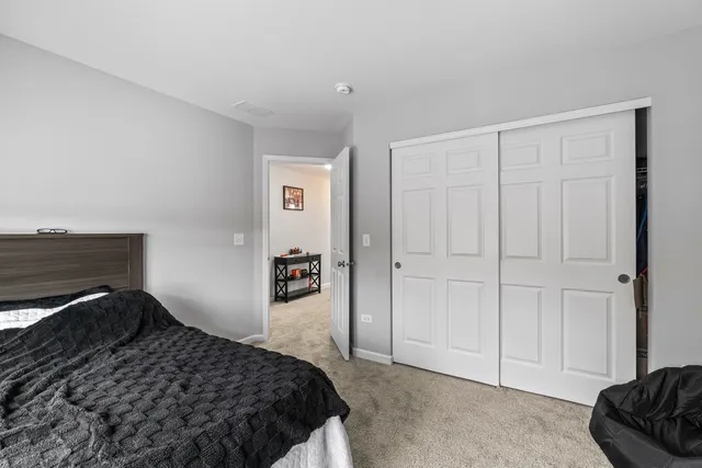 a bedroom with a bed and a closet