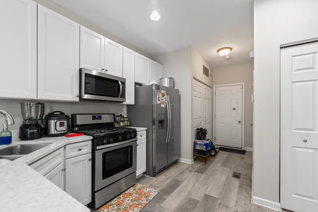 a kitchen with a sink stainless steel appliances and cabinets
