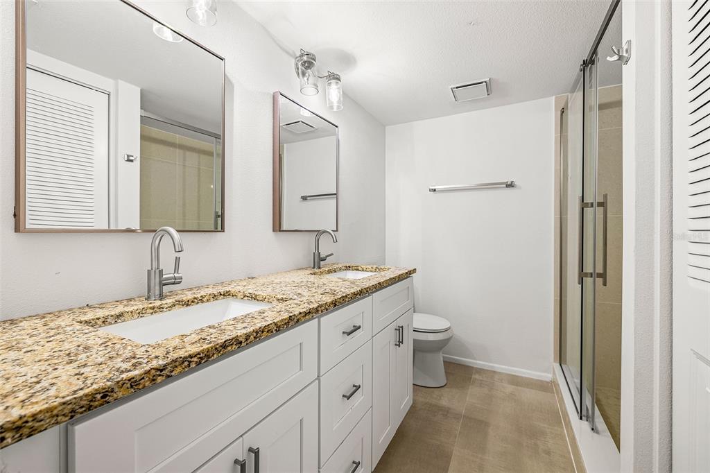 125 Woodlake Wynde Oldsmar, FL 34677 - Photo 14 of 20 a bathroom with a granite countertop sink toilet and shower