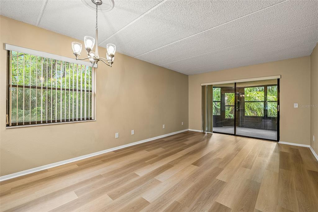 125 Woodlake Wynde Oldsmar, FL 34677 - Photo 5 of 20 a view of an empty room with glass door and windows