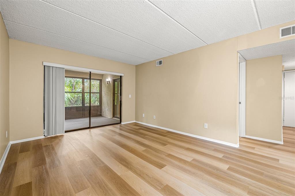 125 Woodlake Wynde Oldsmar, FL 34677 - Photo 6 of 20 a view of an empty room with wooden floor and a window