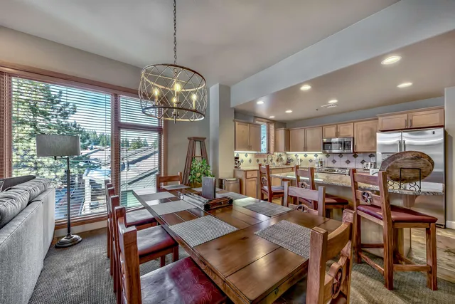 a view of a dining room with furniture wooden floor and chandelier
