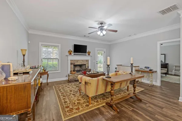 a living room with furniture and a fireplace