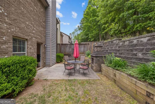 a view of a chairs and table in the backyard