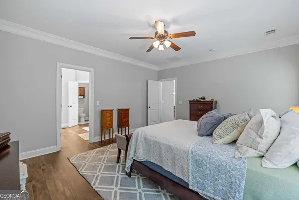 a view of a bathroom with a sink and wooden floor