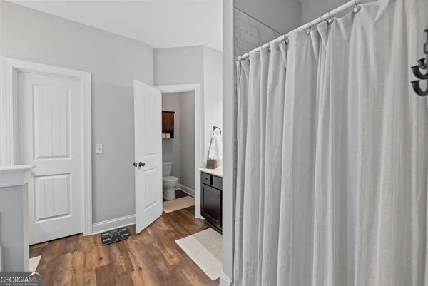 a bathroom with a sink tub and a mirror