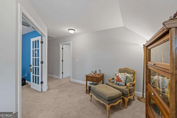 a living room with furniture a air conditioner vent and a window