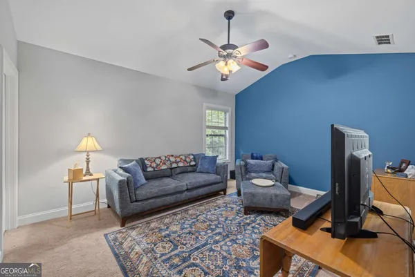 a living room with furniture and a flat screen tv