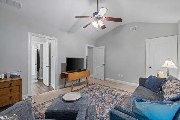 a spacious bedroom with a bed and a chandelier