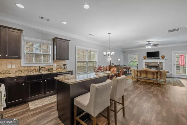 a kitchen with stainless steel appliances granite countertop a sink stove and cabinets