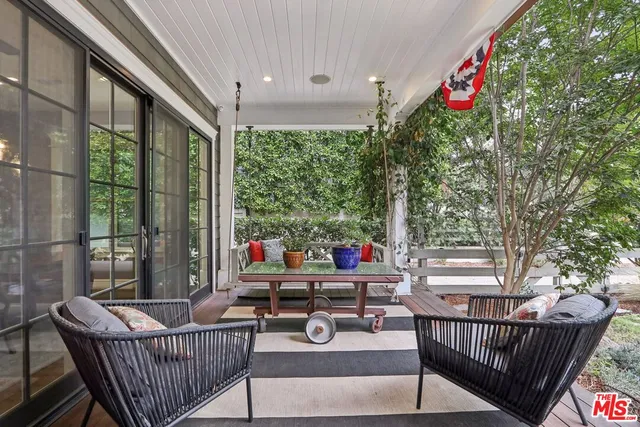 a view of a patio with a wooden deck and furniture