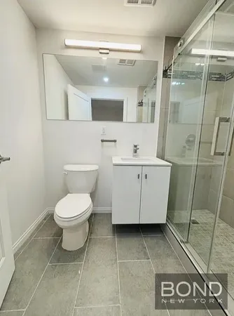 a bathroom with a toilet sink and shower