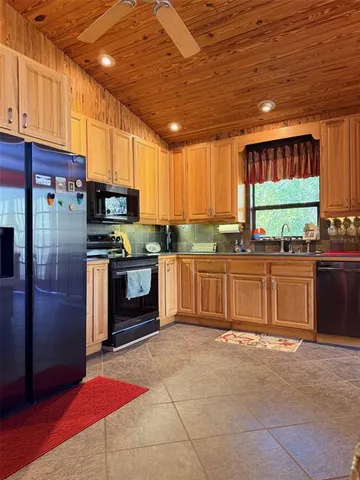 a living room with furniture a large window and a flat screen tv