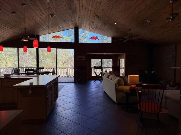 a bedroom with a bed large window with wooden floor