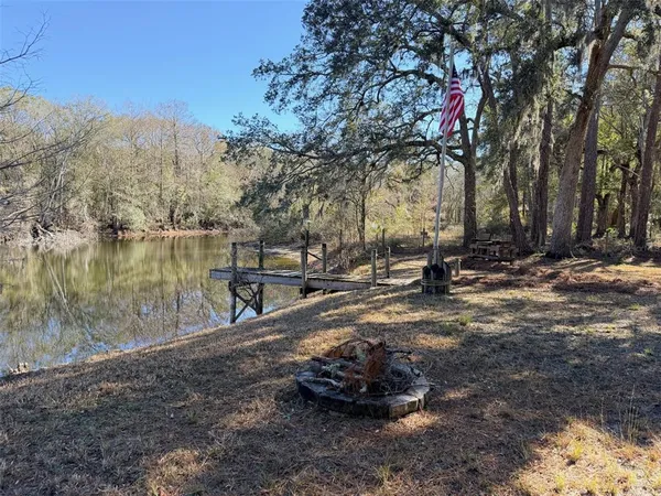 a front view of a house with barbeque grill and floor to ceiling window
