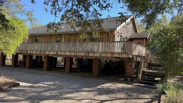 a view of deck with wooden floor and fence with a bench