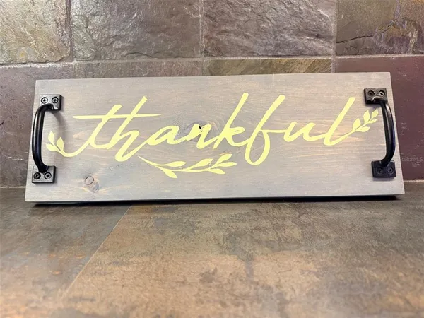 a kitchen with stainless steel appliances a refrigerator cabinets and a window