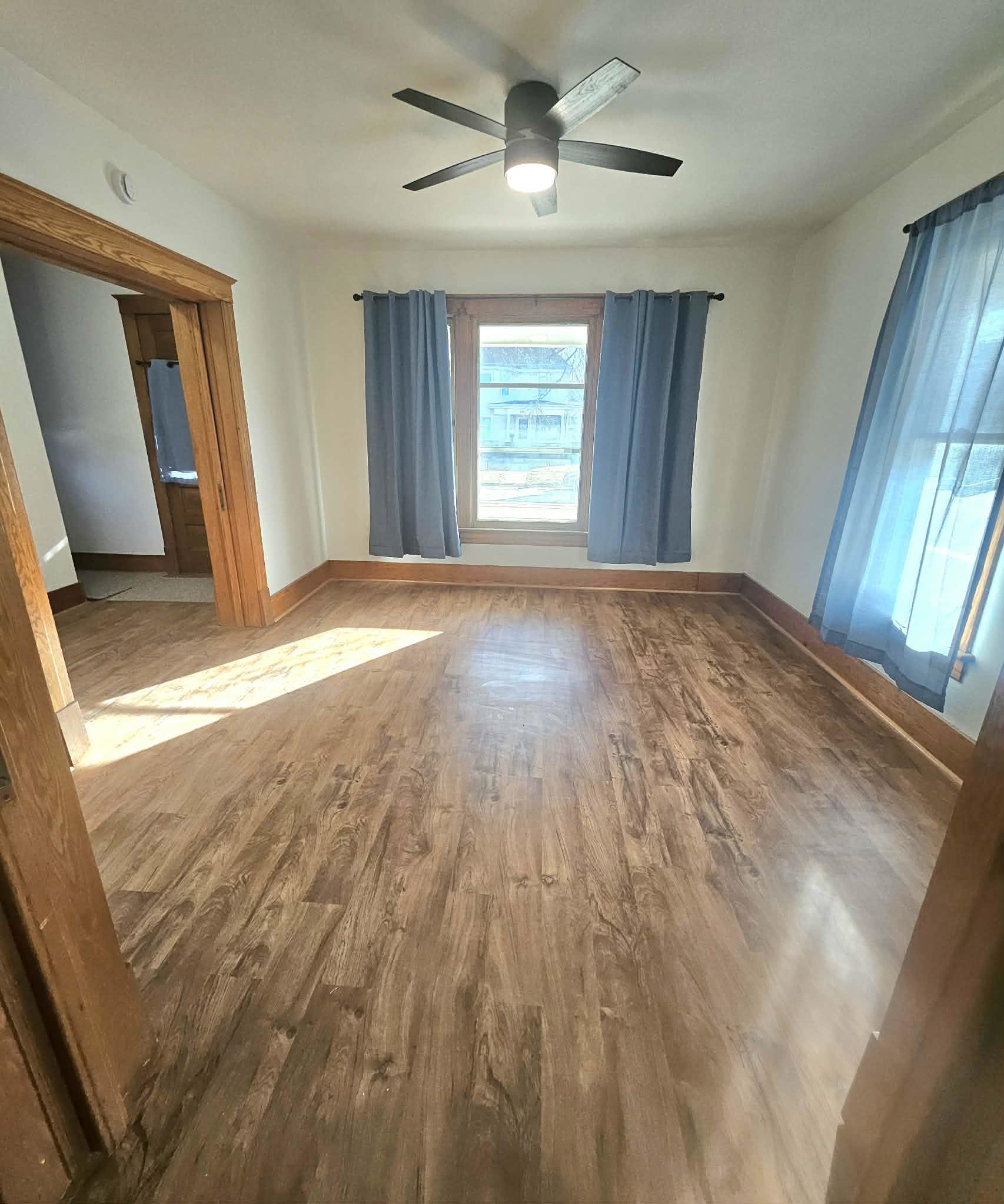 828 9th Street Beloit, WI 53511 - Photo 17 of 23 a view of empty room with wooden floor and fan
