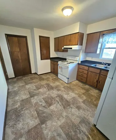 a kitchen with stainless steel appliances a refrigerator sink and microwave