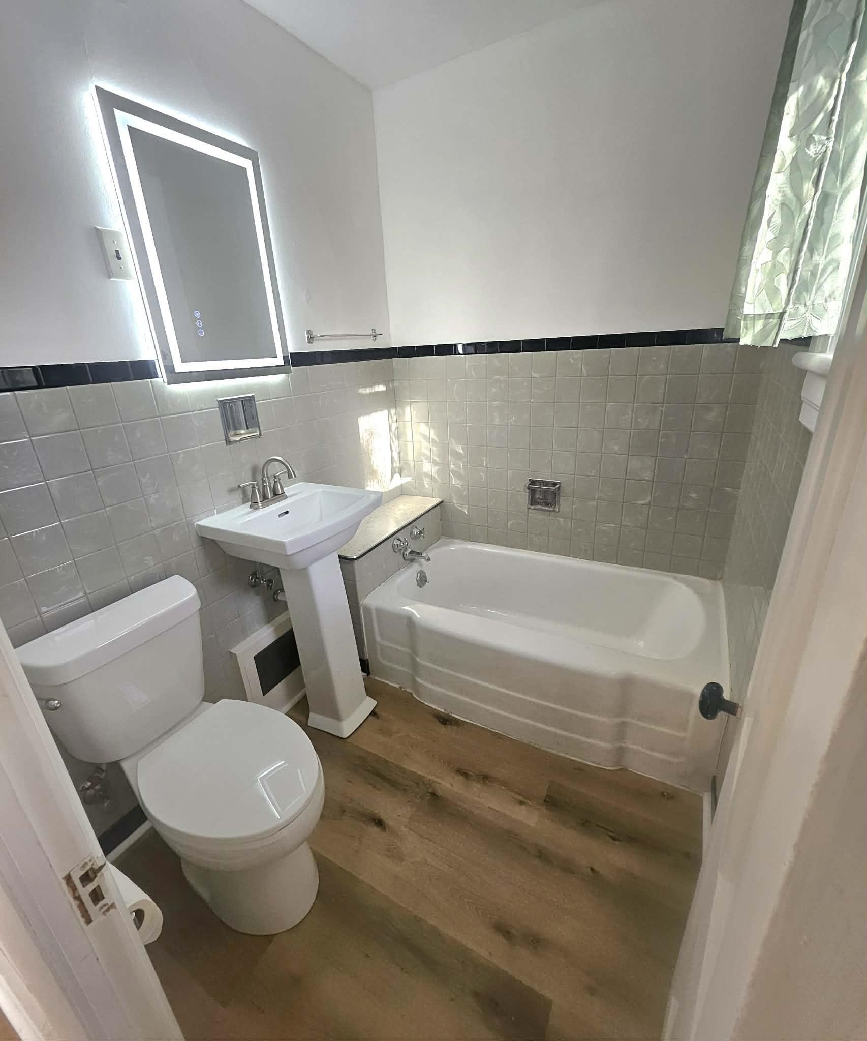 828 9th Street Beloit, WI 53511 - Photo 7 of 23 a bathroom with a toilet a sink and a bathtub