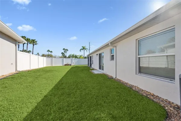a view of a house with backyard and porch