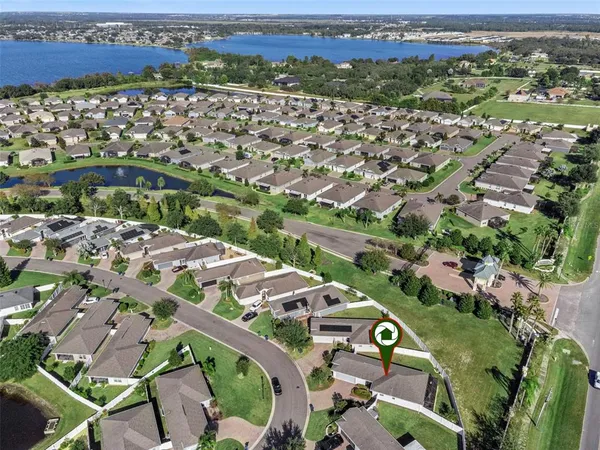 an aerial view of a house with a yard basket ball court and outdoor seating