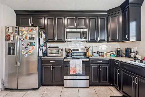 a kitchen with stainless steel appliances granite countertop a stove and a refrigerator