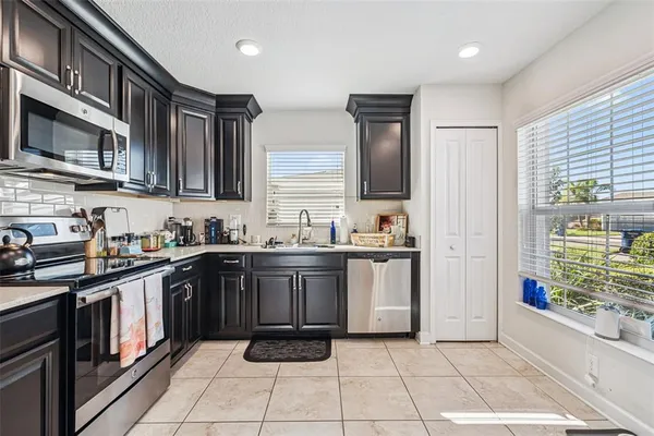 a kitchen with a sink window and cabinets