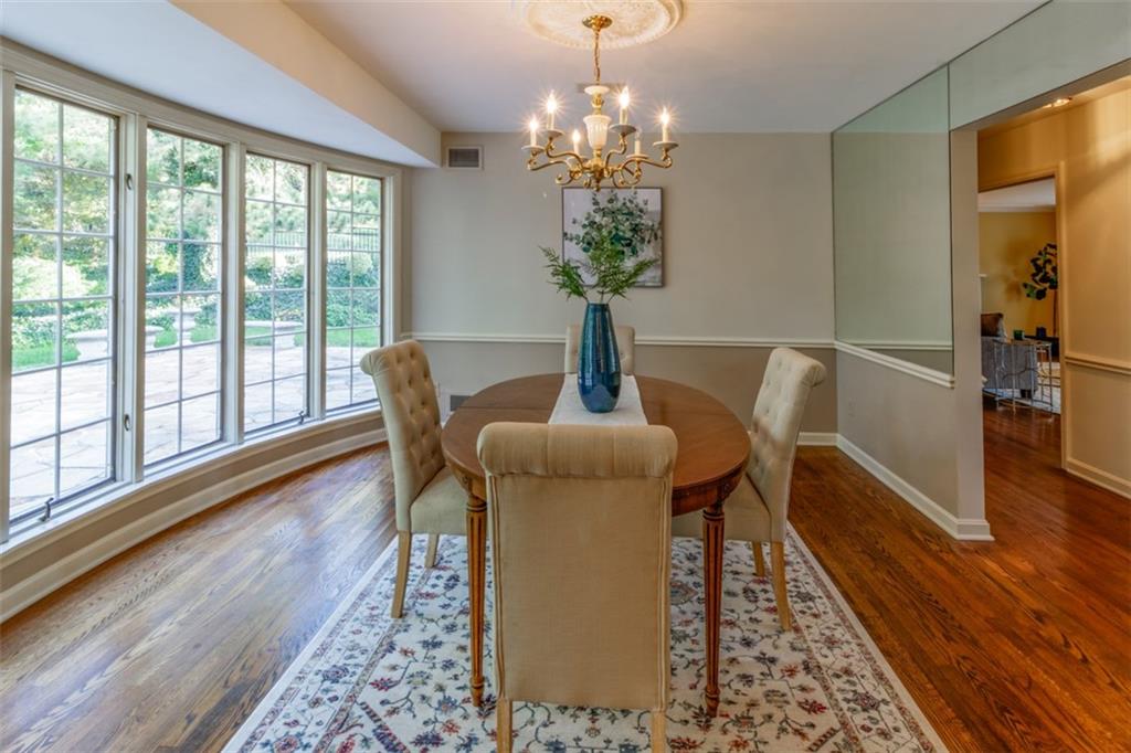 192 Devonwood Drive Pittsburgh, PA 15241 - Photo 7 of 25 a dining room with furniture wooden floor a rug a potted plant and a chandelier