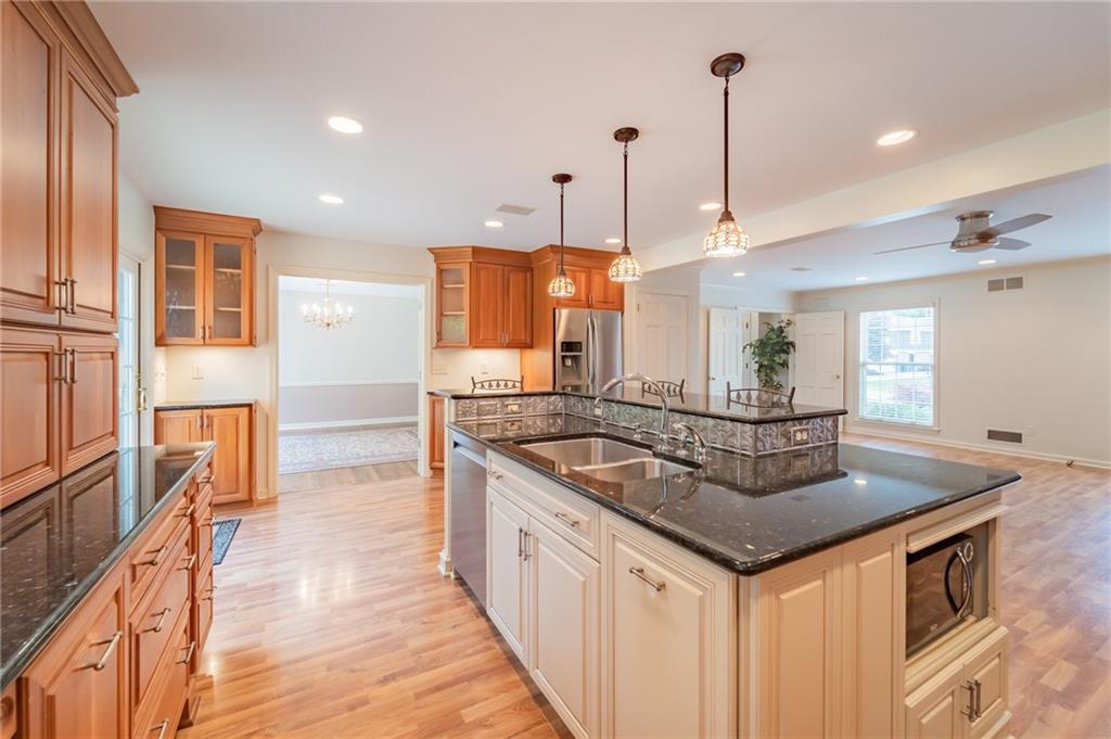 192 Devonwood Drive Pittsburgh, PA 15241 - Photo 9 of 25 a kitchen with stainless steel appliances granite countertop a sink a stove and a wooden floor