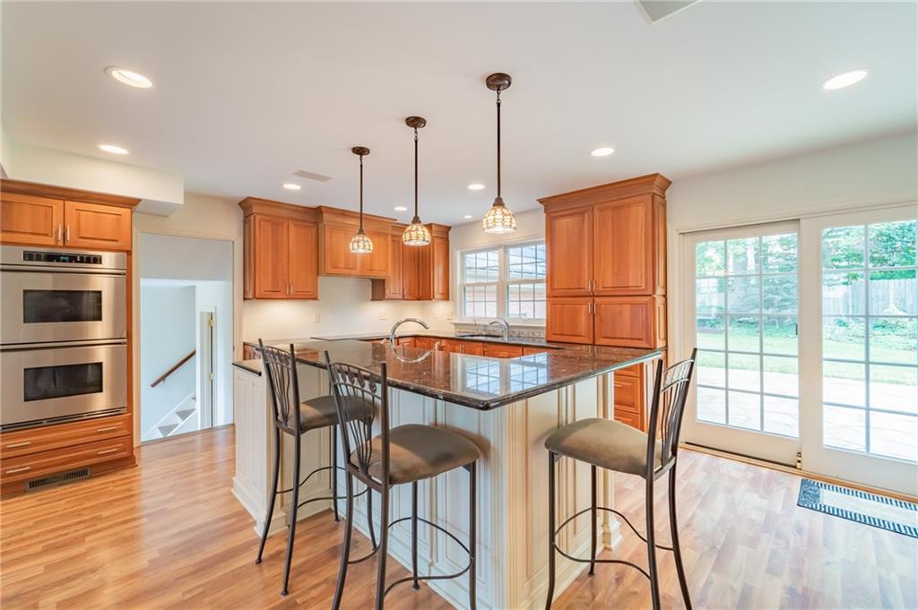 192 Devonwood Drive Pittsburgh, PA 15241 - Photo 10 of 25 a kitchen with stainless steel appliances granite countertop a stove top oven a sink with a dining table and chairs