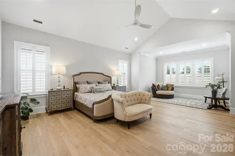 a bedroom with furniture and a chandelier