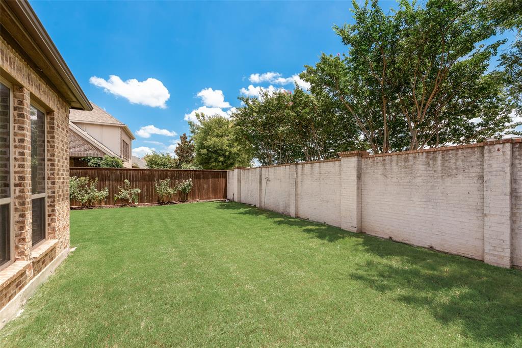 2021 Calisto Way Allen, TX 75013 - Photo 33 of 34 Expansive grass lawn bordered by a brick privacy wall and a wood fence