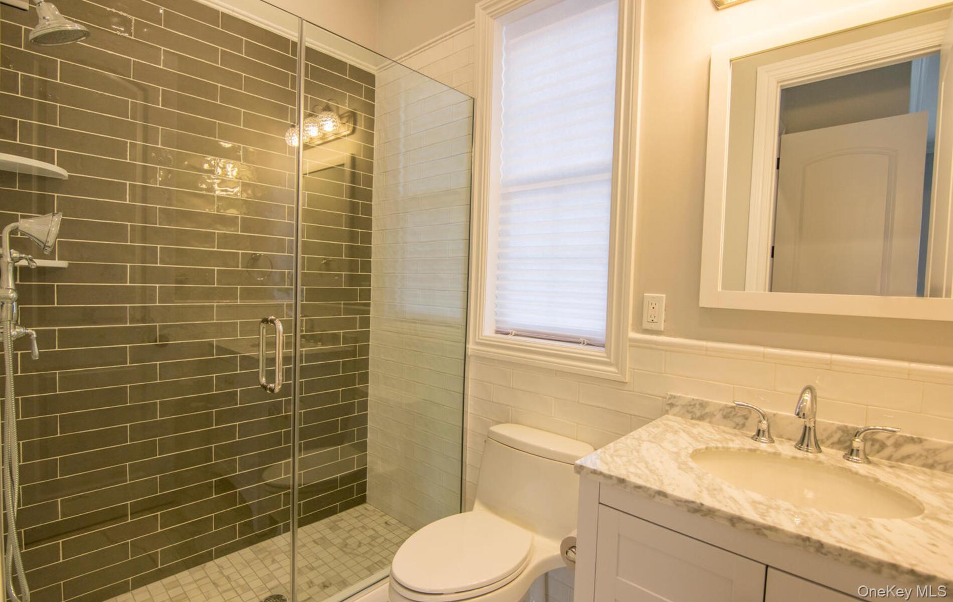 2 Seaman Road Glen Cove, NY 11542 - Photo 6 of 15 a bathroom with a sink toilet and shower