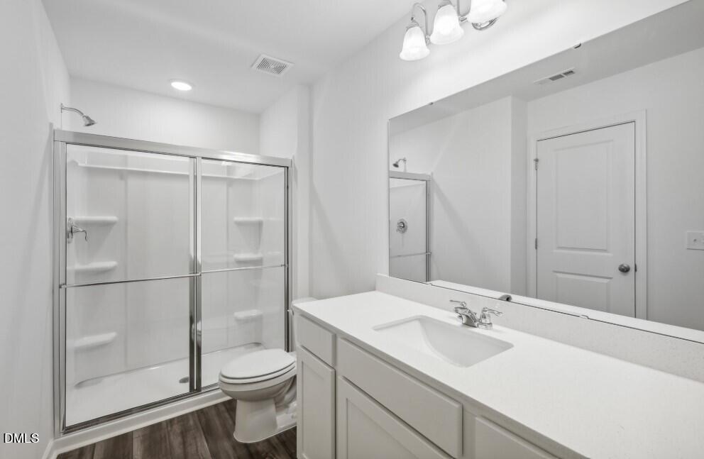 2139 Gln Xing Drive Durham, NC 27704 - Photo 14 of 20 a bathroom with a sink toilet and shower
