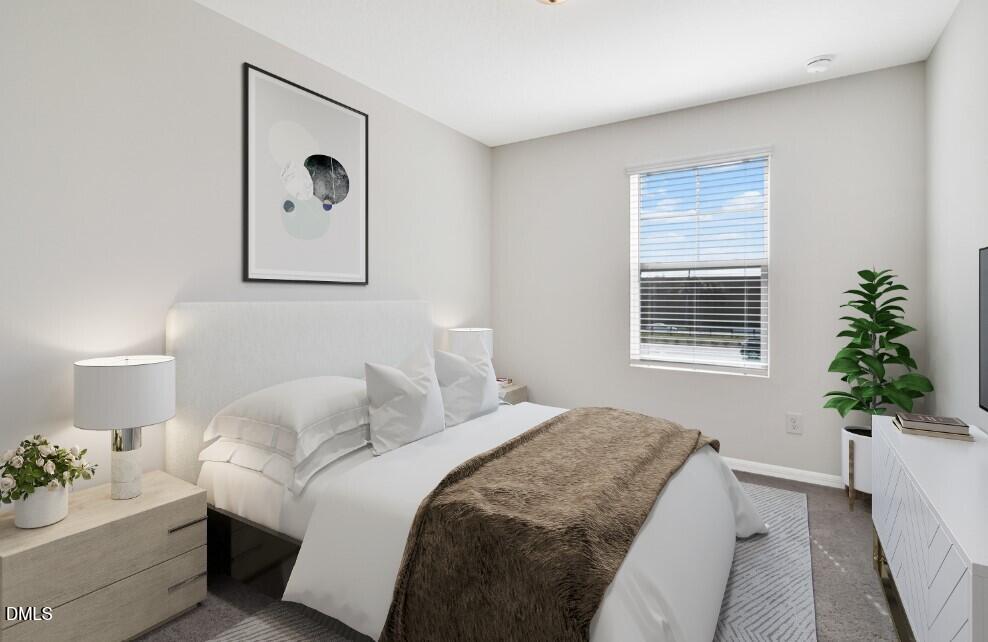 2139 Gln Xing Drive Durham, NC 27704 - Photo 4 of 20 a bedroom with a bed and a potted plant