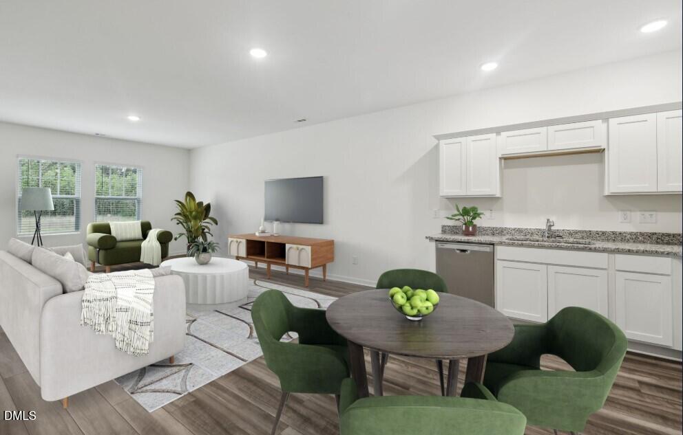 2139 Gln Xing Drive Durham, NC 27704 - Photo 5 of 20 a living room with furniture a kitchen view and a wooden floor