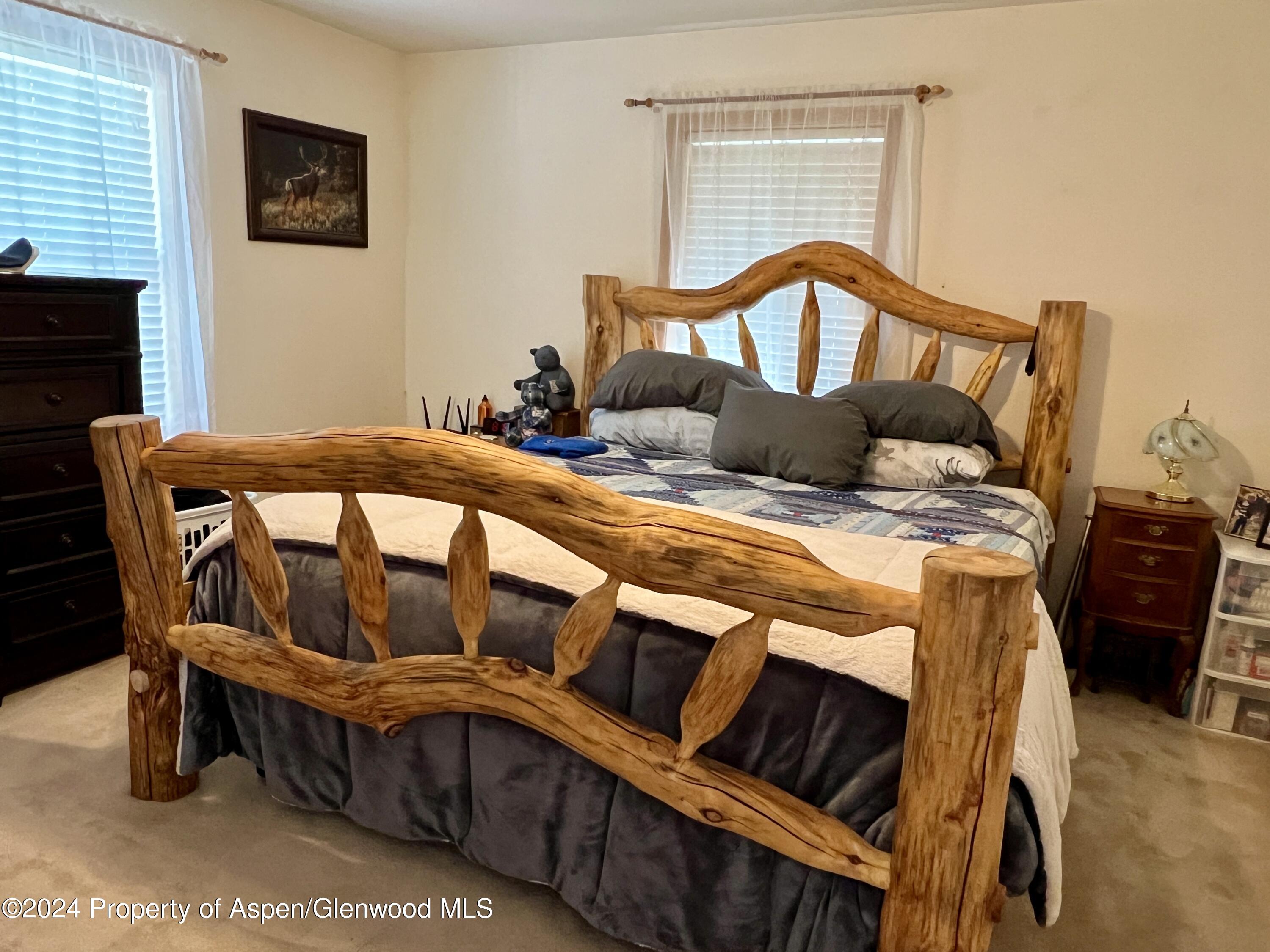 709 Rimrock Drive Meeker, CO 81641 - Photo 11 of 27 a bedroom with a bed chair and a window