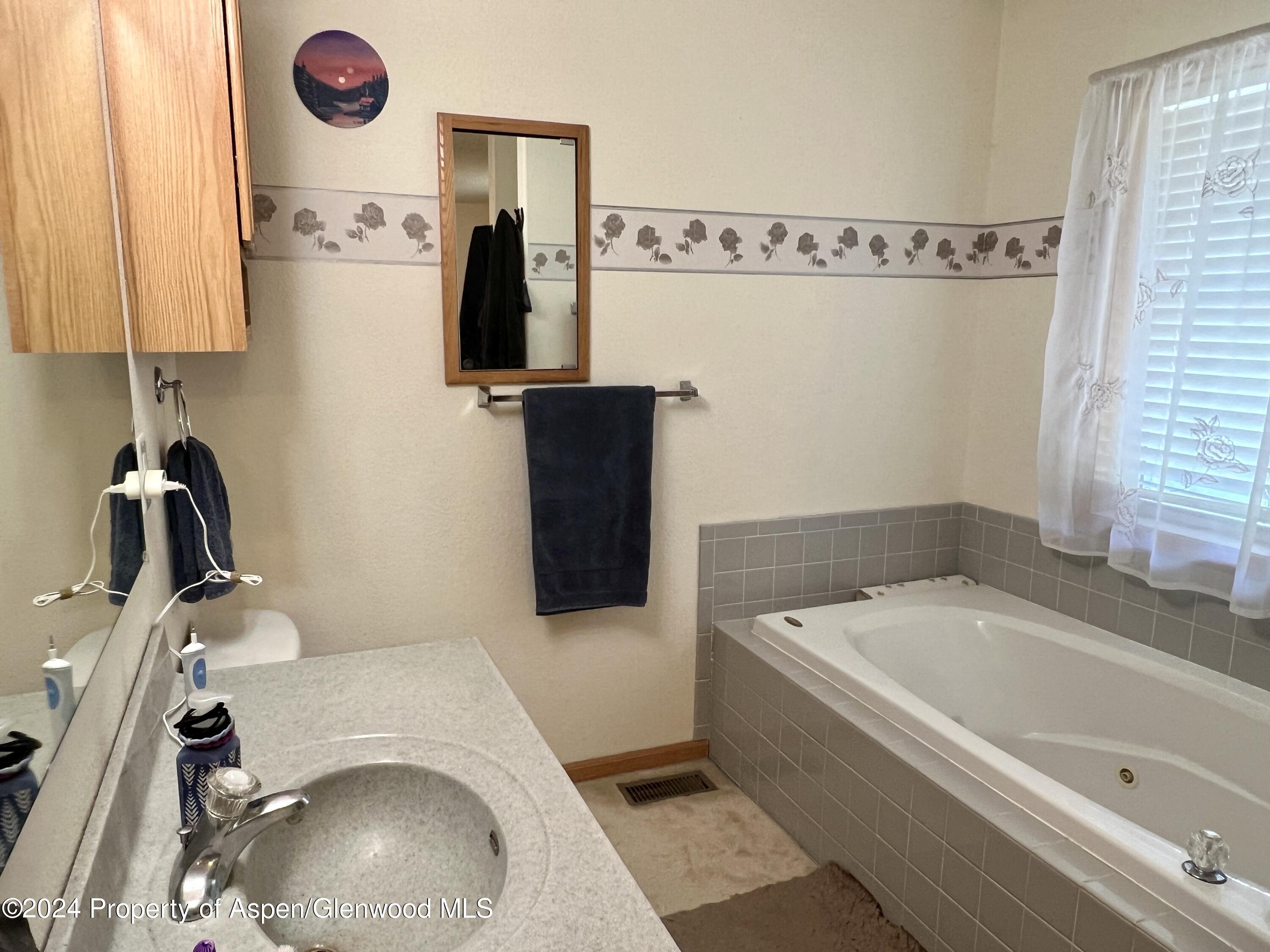 709 Rimrock Drive Meeker, CO 81641 - Photo 12 of 27 a bathroom with a toilet and a tub