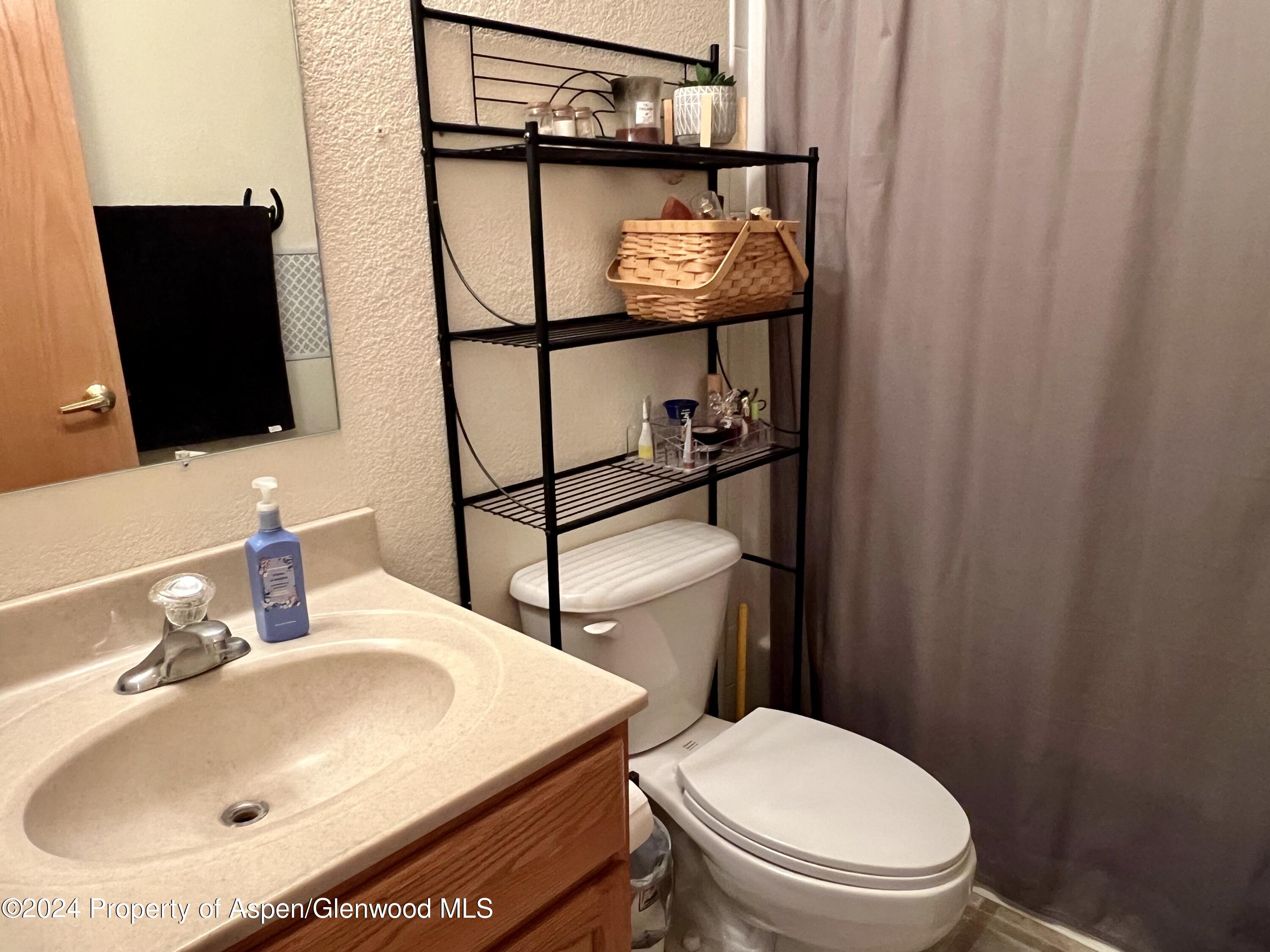 709 Rimrock Drive Meeker, CO 81641 - Photo 14 of 27 a bathroom with a sink toilet and mirror