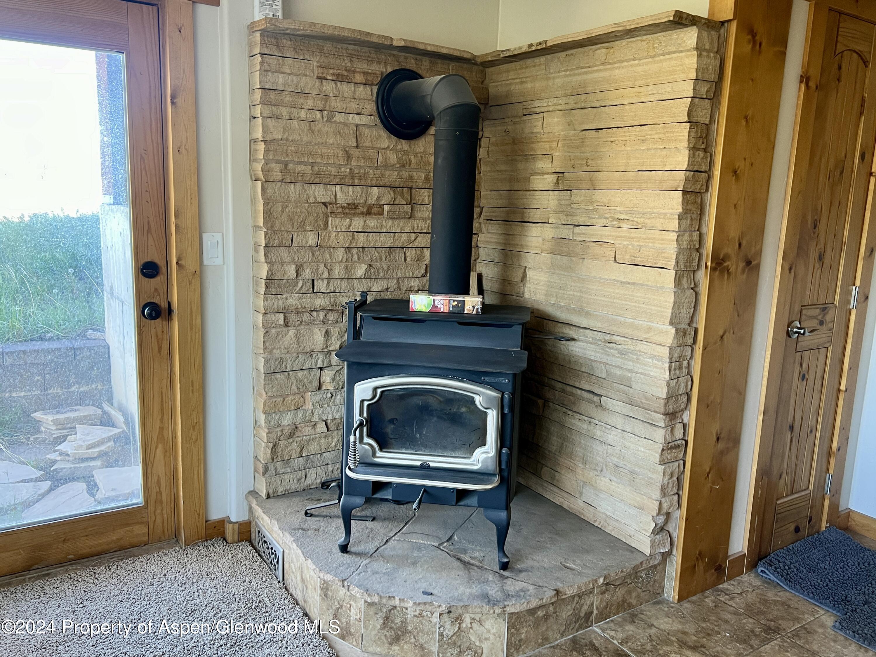 709 Rimrock Drive Meeker, CO 81641 - Photo 16 of 27 a living room with furniture and a fireplace