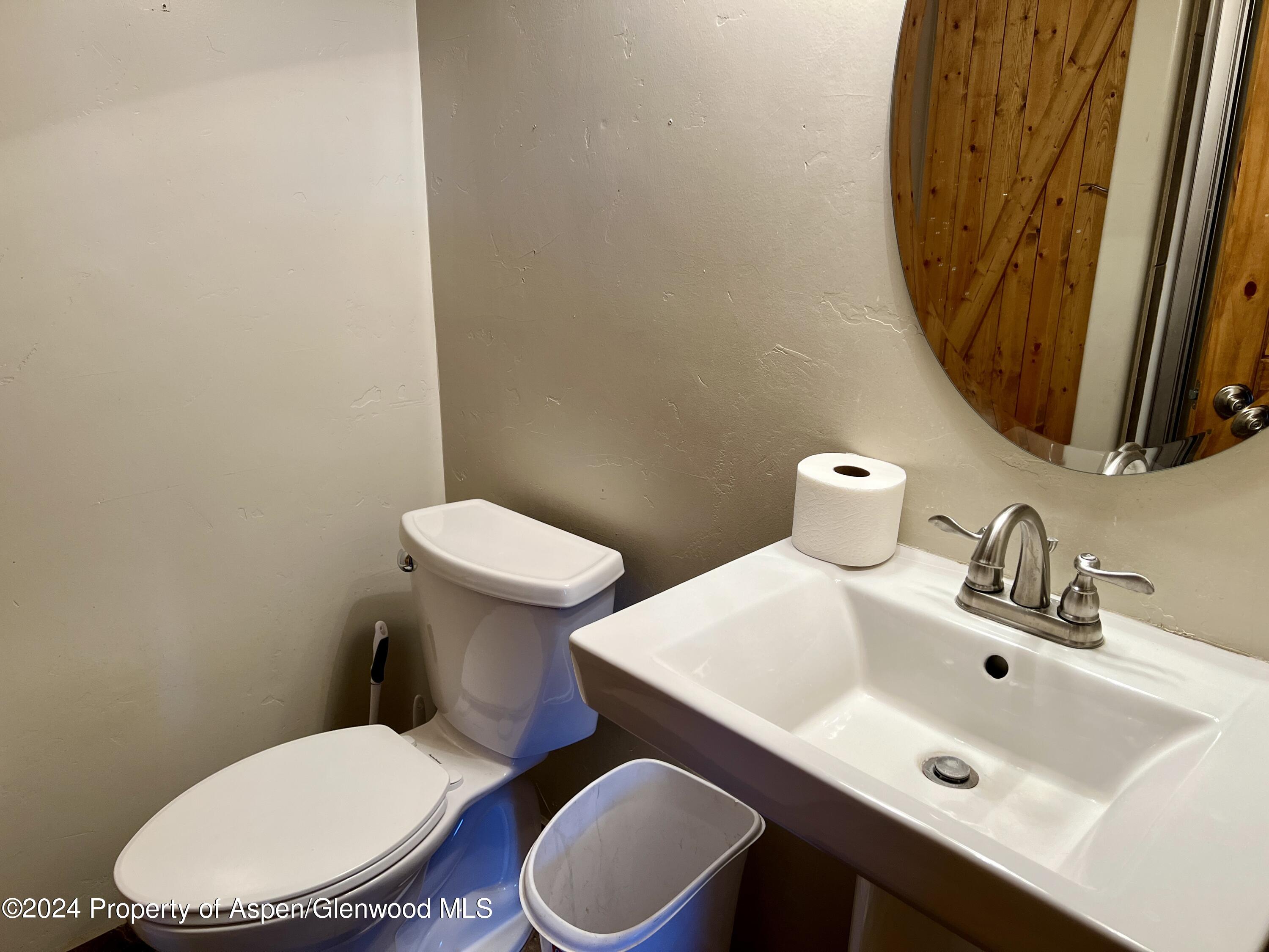 709 Rimrock Drive Meeker, CO 81641 - Photo 19 of 27 a white toilet sitting next to a bathroom sink