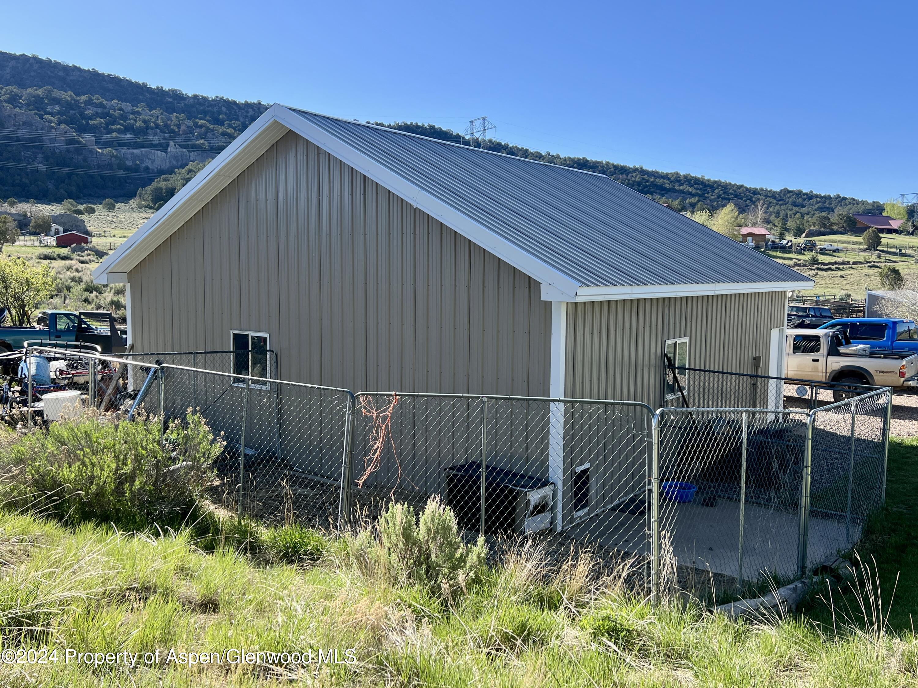 709 Rimrock Drive Meeker, CO 81641 - Photo 22 of 27 a backyard of a house with plants and outdoor seating