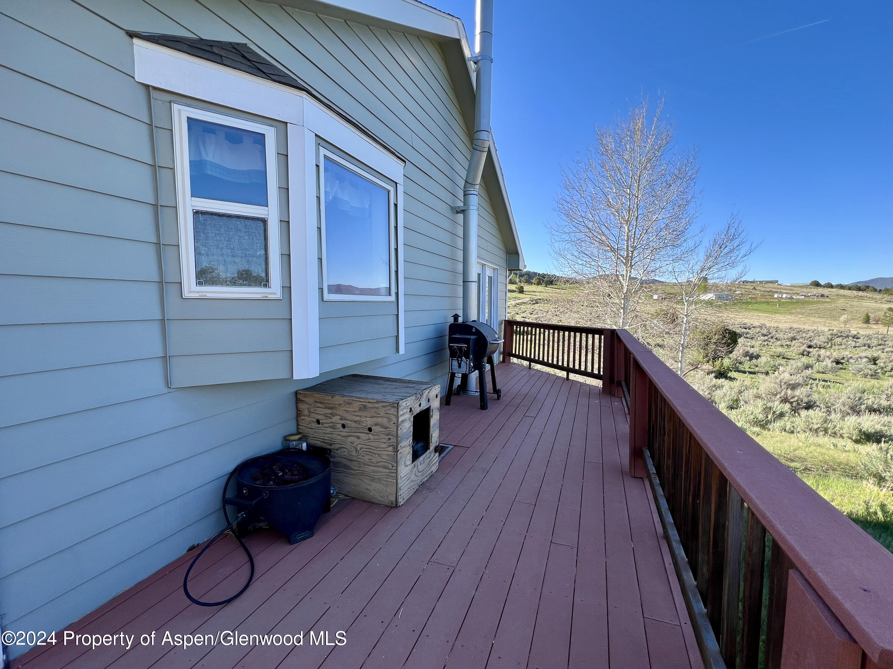 709 Rimrock Drive Meeker, CO 81641 - Photo 3 of 27 a balcony with wooden floor and furniture
