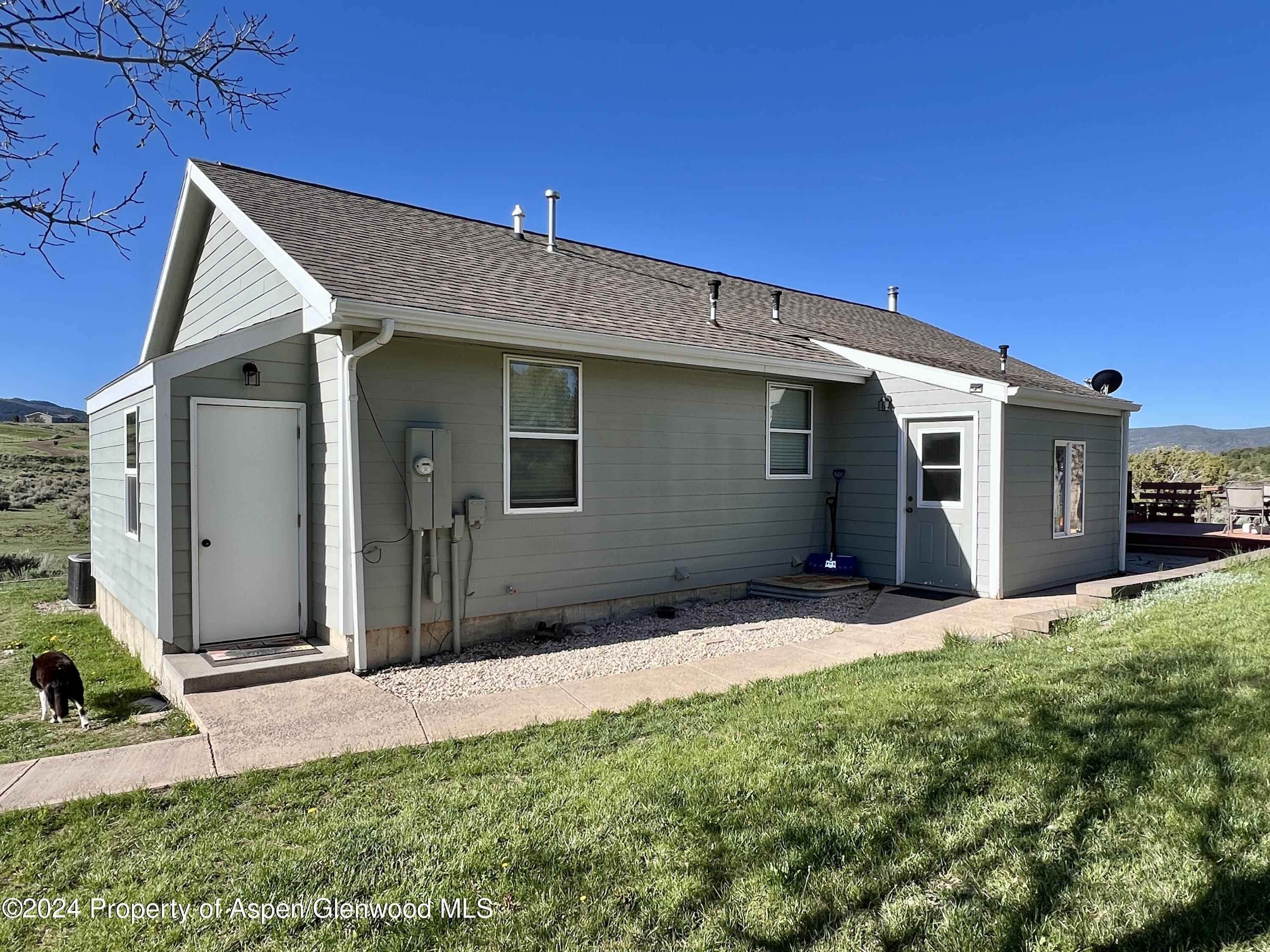 709 Rimrock Drive Meeker, CO 81641 - Photo 6 of 27 a backyard of a house with seating space