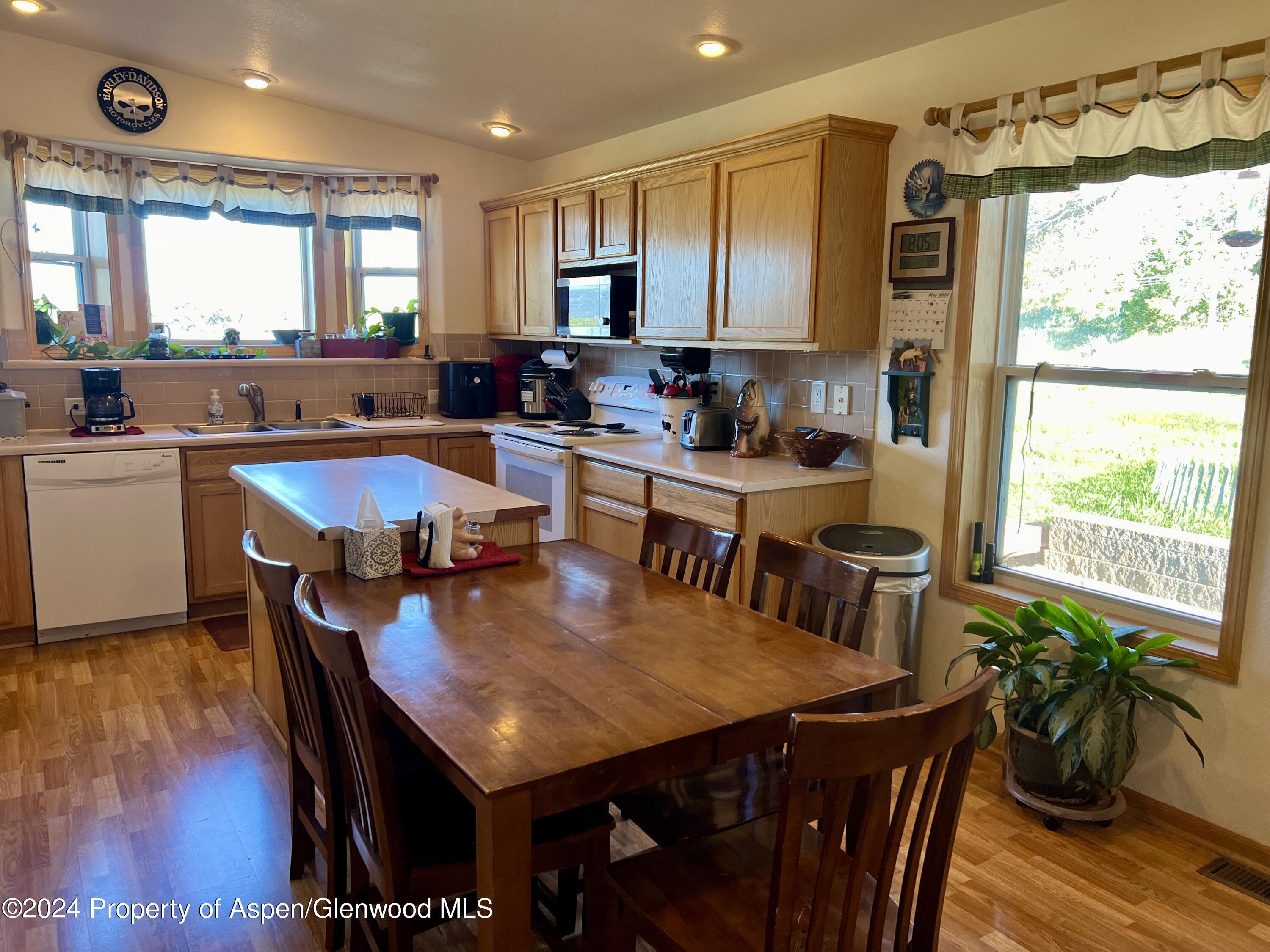 709 Rimrock Drive Meeker, CO 81641 - Photo 9 of 27 a kitchen with a table chairs sink and cabinets